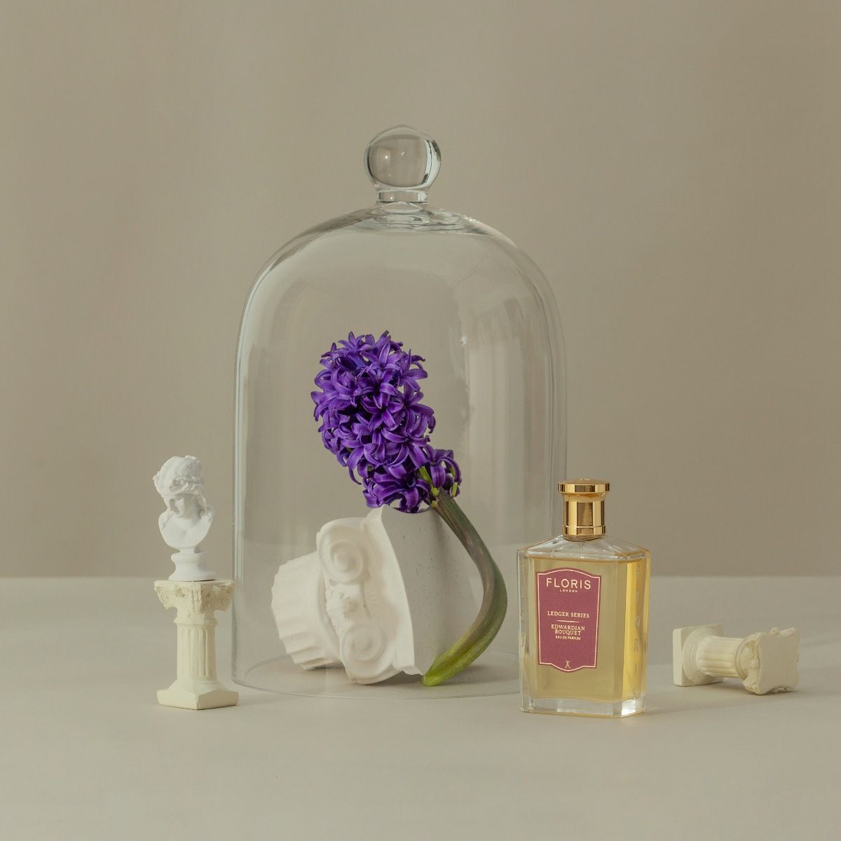 Edwardian Bouquet perfume from Floris shown with a bell jar and hyacinth bloom